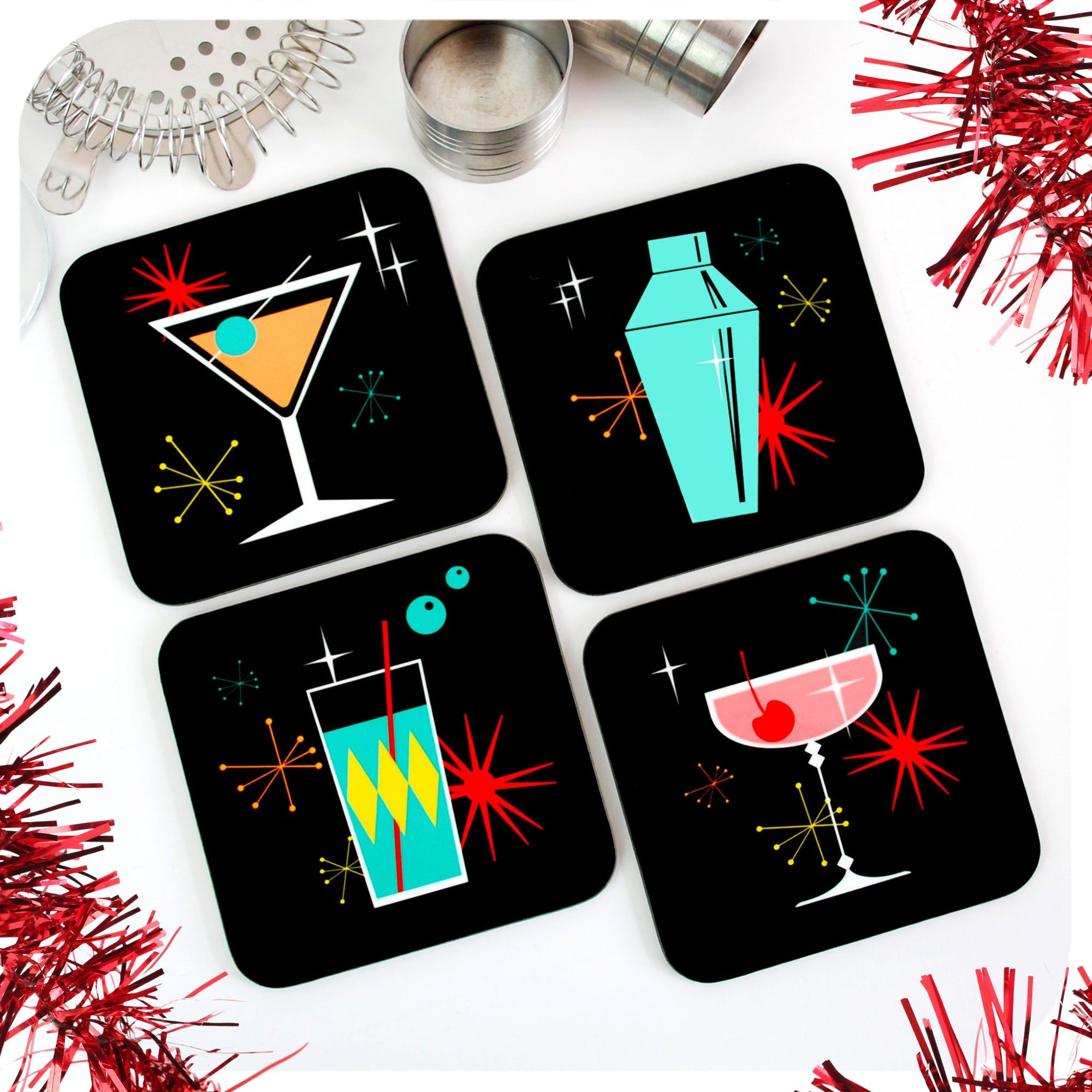 Set of four square retro cocktail coasters lie on a white table with cocktail making equipment and red tinsel | The Inkabilly Emporium