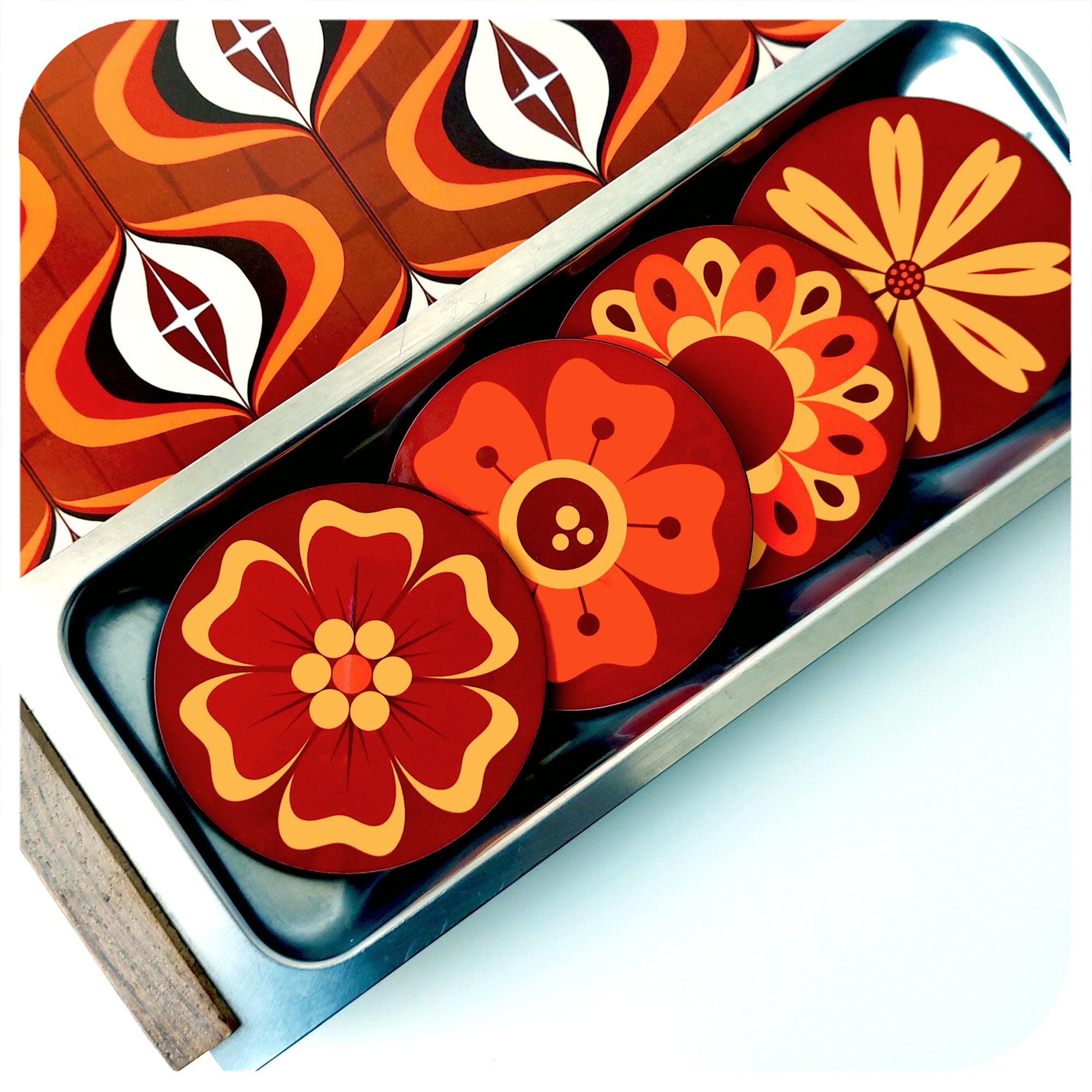 A set of four 70s style floral coasters in a vintage metal serving tray next to a 70s style patterned placemat | The Inkabilly Emporium