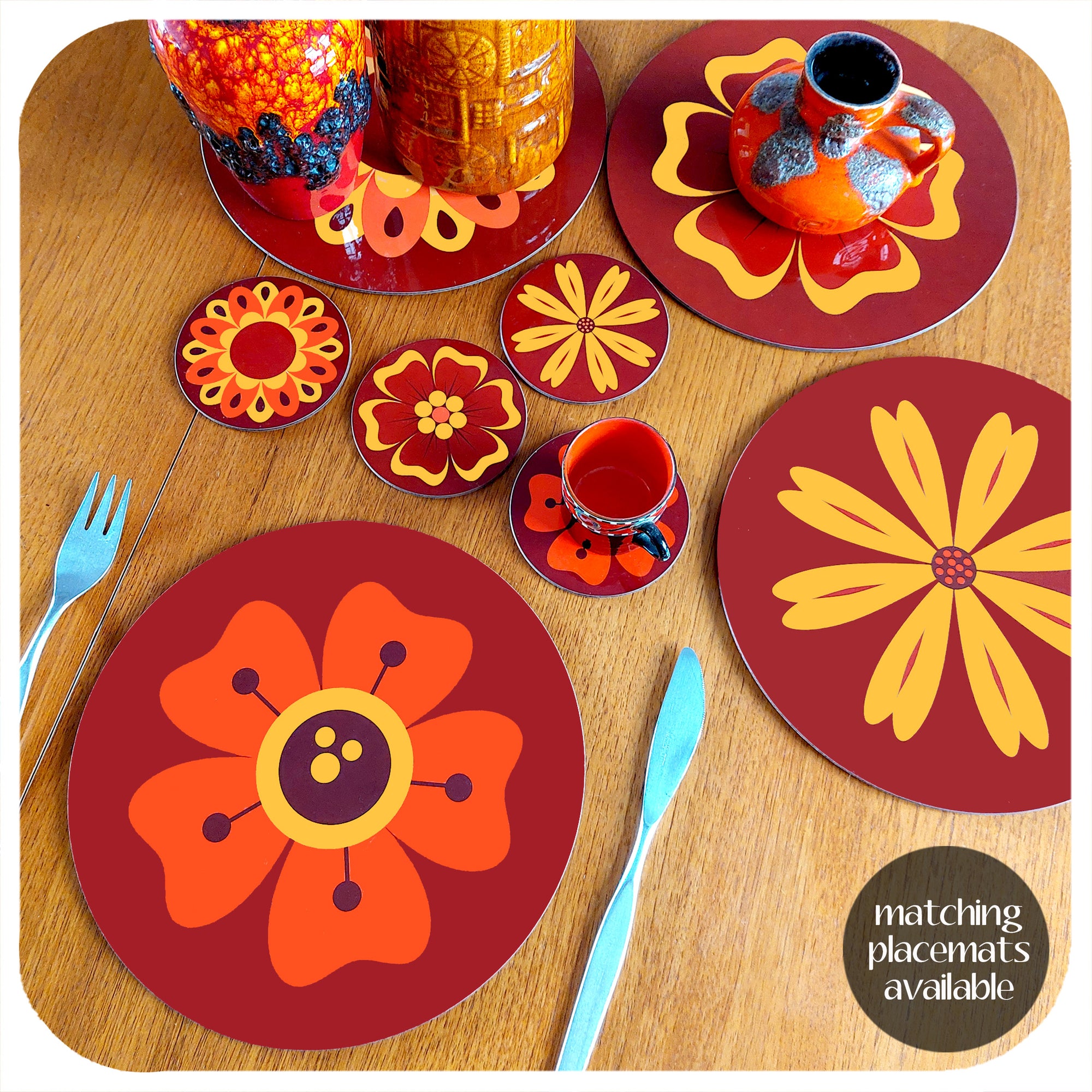 70s style floral coasters and placemats on a teak table with vintage fat lava vases. Text in  bottom right corner reads: matching placemats available | The Inkabilly Emporium