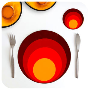 70s style round placemat and matching coaster are set on a white table with mid century cutlery and a couple of orange 70s glass dishes | The Inkabilly Emporium