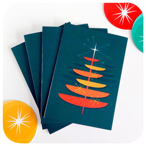 Four Retro Christmas tree cards lie on a white table with 50s style Christmas decorations | The Inkabilly Emporium