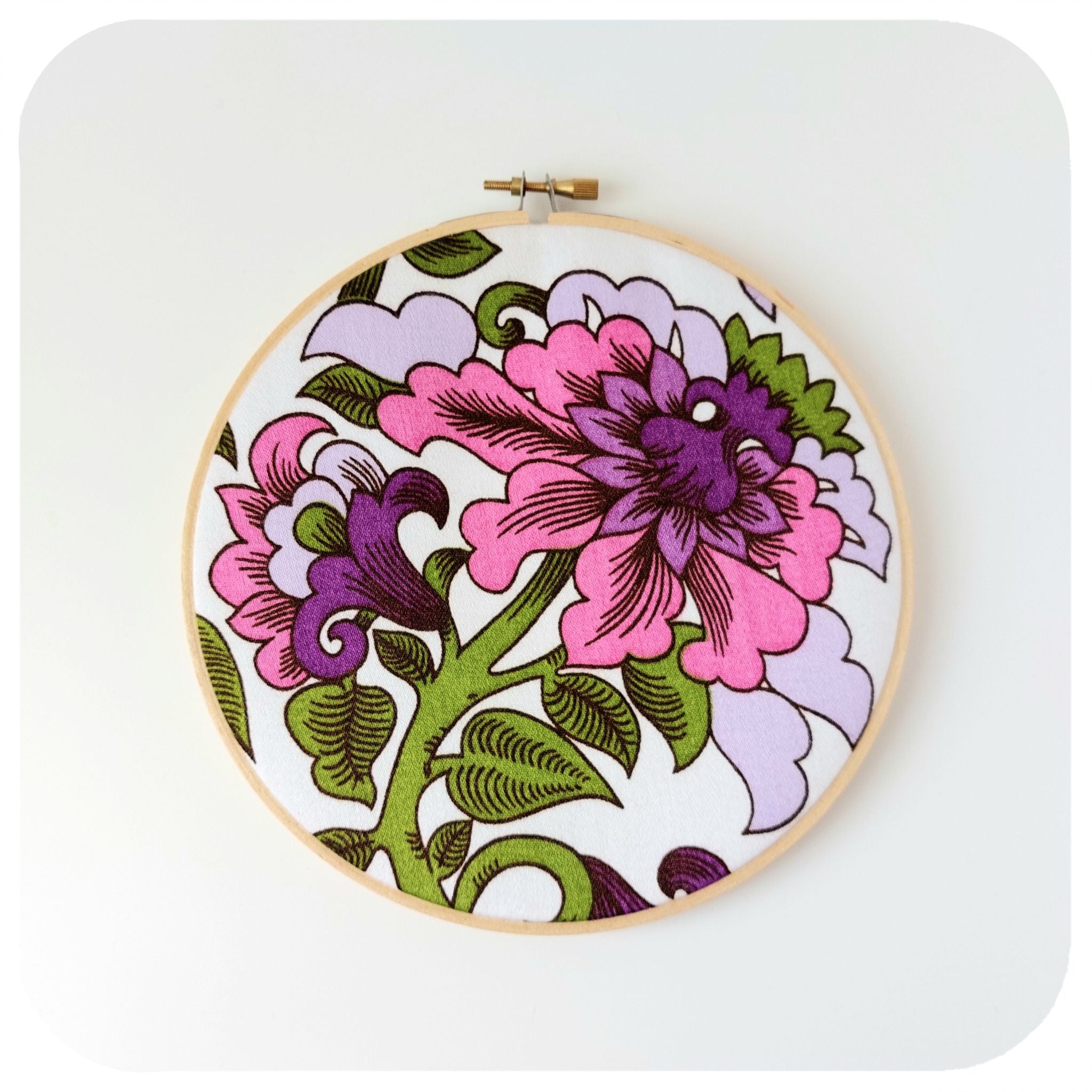 Floral embroidery hoop art on a white background