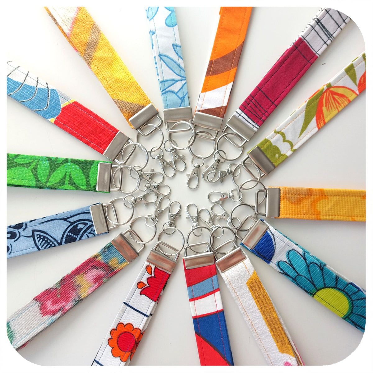 Colourful fabric keychains arranged in a circular pattern on a white background | The Inkabilly Emporium