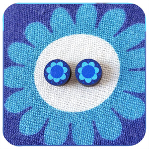 Blue floral stud earrings on matching blue floral fabric