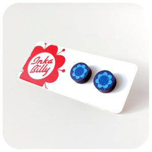 Blue flower-shaped earrings on a white card with 'InkaBilly' branding.