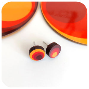 Colourful circular earrings on a white background