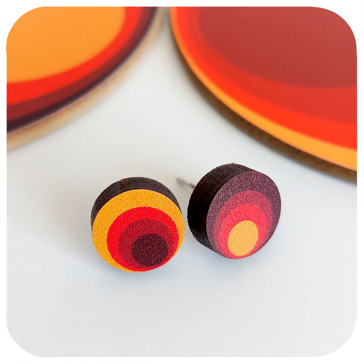 Colourful circular earrings on a white background