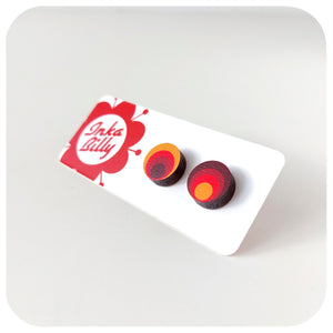 Colourful circular earrings on a white card with 'Inkabilly' branding.