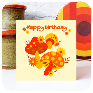 70s Mushrooms Birthday Card standing with vintage vase and retro graphic art against a white brick wall | The Inkabilly Emporium