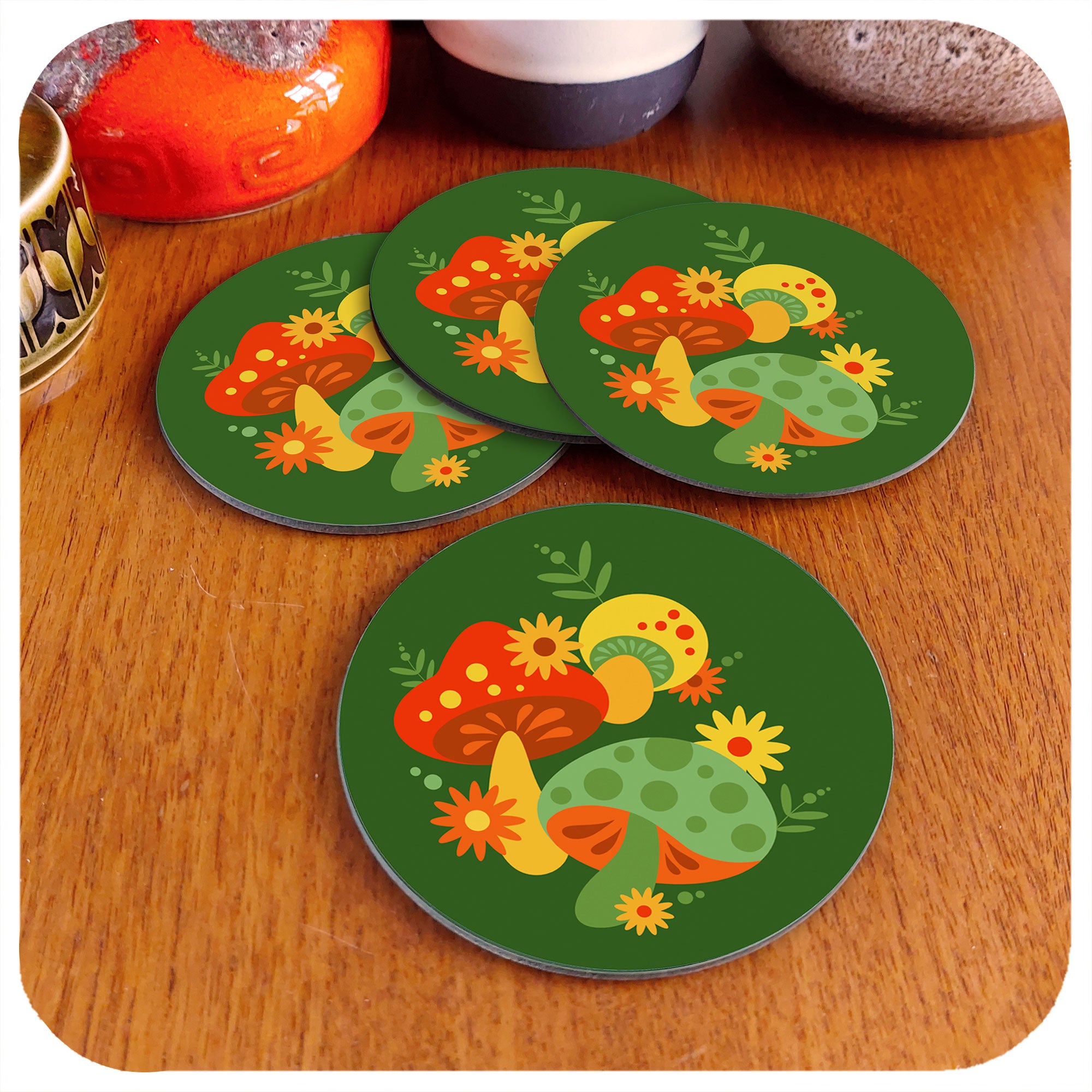 Set of 4 retro 70s style mushroom coasters lie on a teak table next to vintage Fat Lava and Hornsea pottery jugs | The Inkabilly Emporium