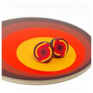 Colourful retro style circular earrings on a round, multicoloured surface | The Inkabilly Emporium