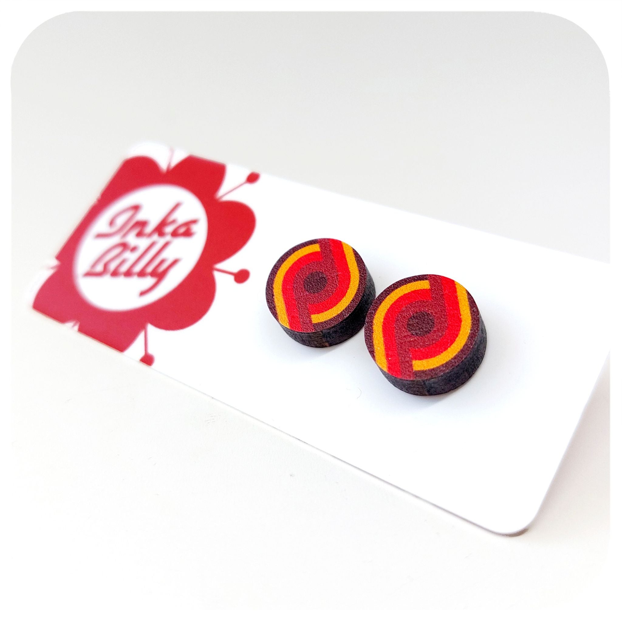 Pair of round earrings with red and yellow design on a white card with 'InkaBilly' branding.