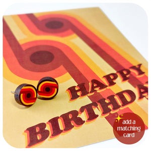 70s style Happy Birthday card with red and yellow stud earrings on a white background. Text in bottom right-hand corner reads: add a matching card | The Inkabilly Emproium
