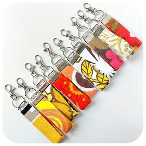 Set of colourful keychains with various patterns on a white background