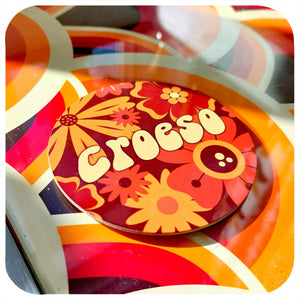 Colorful vintage-style coaster with floral design and 'Croeso' text.