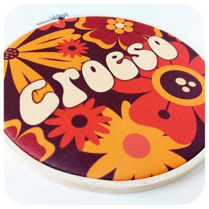 Decorative hoop with colourful floral design and 'Croeso' text on a white background