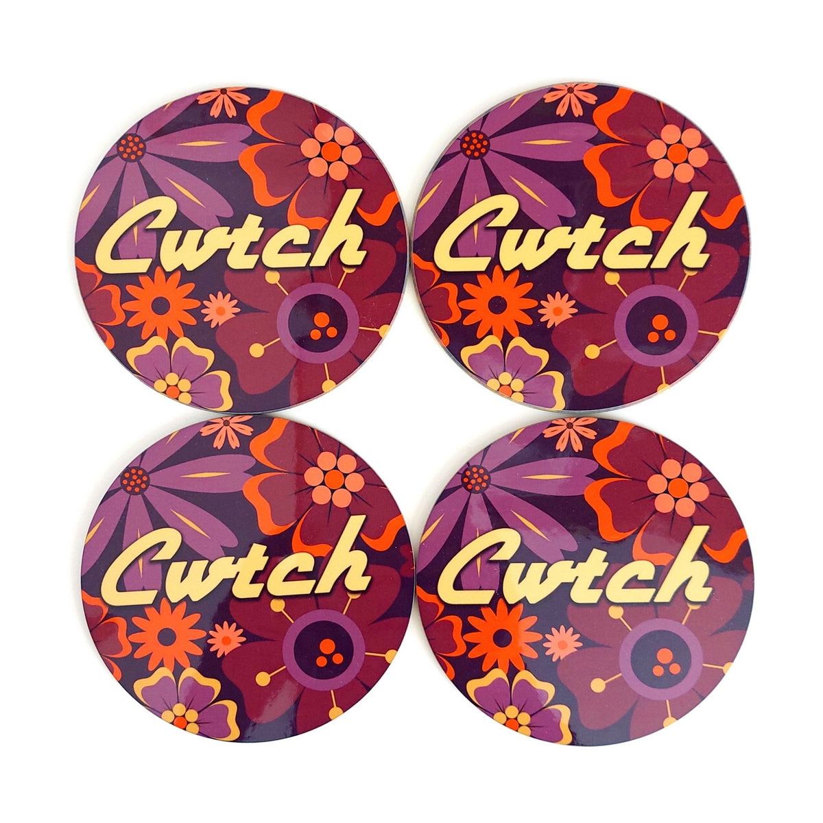 Four round coasters with floral design and 'Cwtch' text on a white background