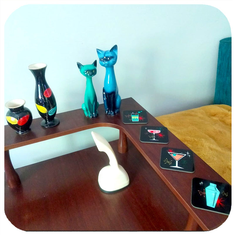 Customer photo of retro cocktail coasters on a vintage mid century coffee table with mid century vases and vintage ceramic cats