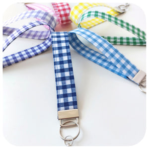 Set of colourful checkered lanyards with metal clips on a white background