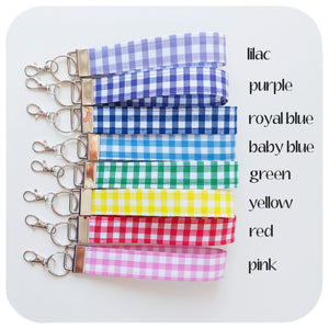 Set of gingham keychains in various colours on a white background, text included to depict each colour