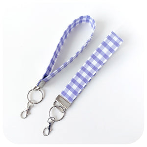 Lanyard with key holder featuring a lilac and white checkered pattern on a white background