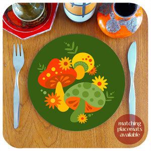 A round 70s style placemat featuring cute graphic mushrooms, with cutlery and vintage pottery pieces lie on a teak table. Text in the bottom right hand corner reads " matching placemats available "  |The Inkabilly Emporium