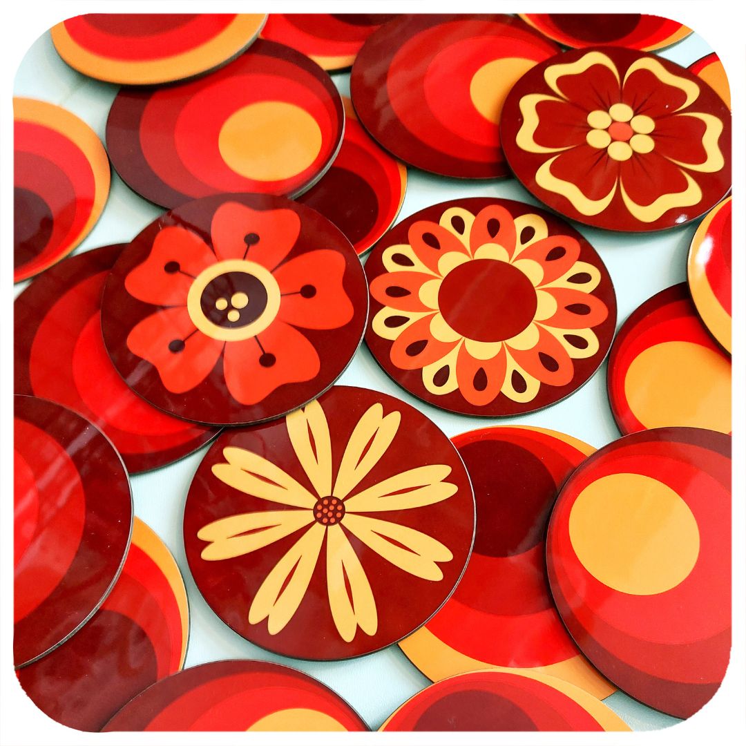 Collection of red and orange floral coasters on a white background