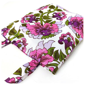 Floral patterned fabric with pink and purple flowers on a white background