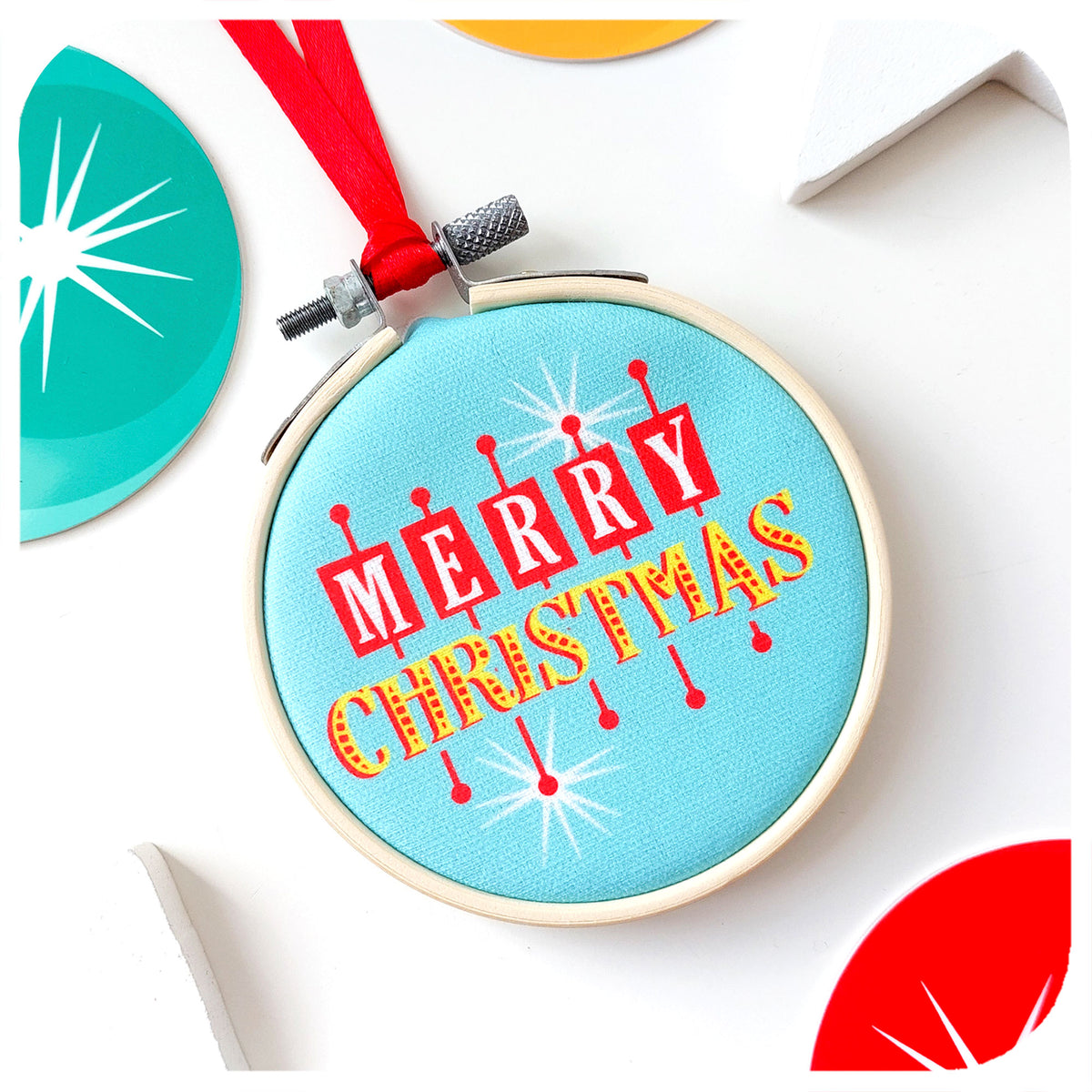 A printed fabric Christmas tree decoration in Atomic Era style on a white background surrounded by colourful Christmas decorations | The Inkabilly Emporium