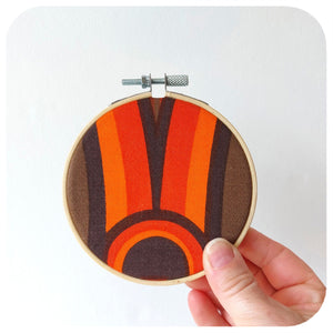Framed vintage fabric hoop in 70s graphic held against a white background | The Inkabilly Emporium