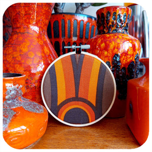 Framed vintage fabric hoop in 70s graphic leaning against vintage fat lava pottery | The Inkabilly Emporium