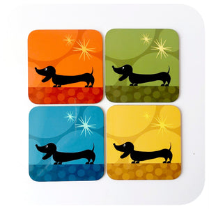 Four colourful coasters with dachshund silhouettes on a white background