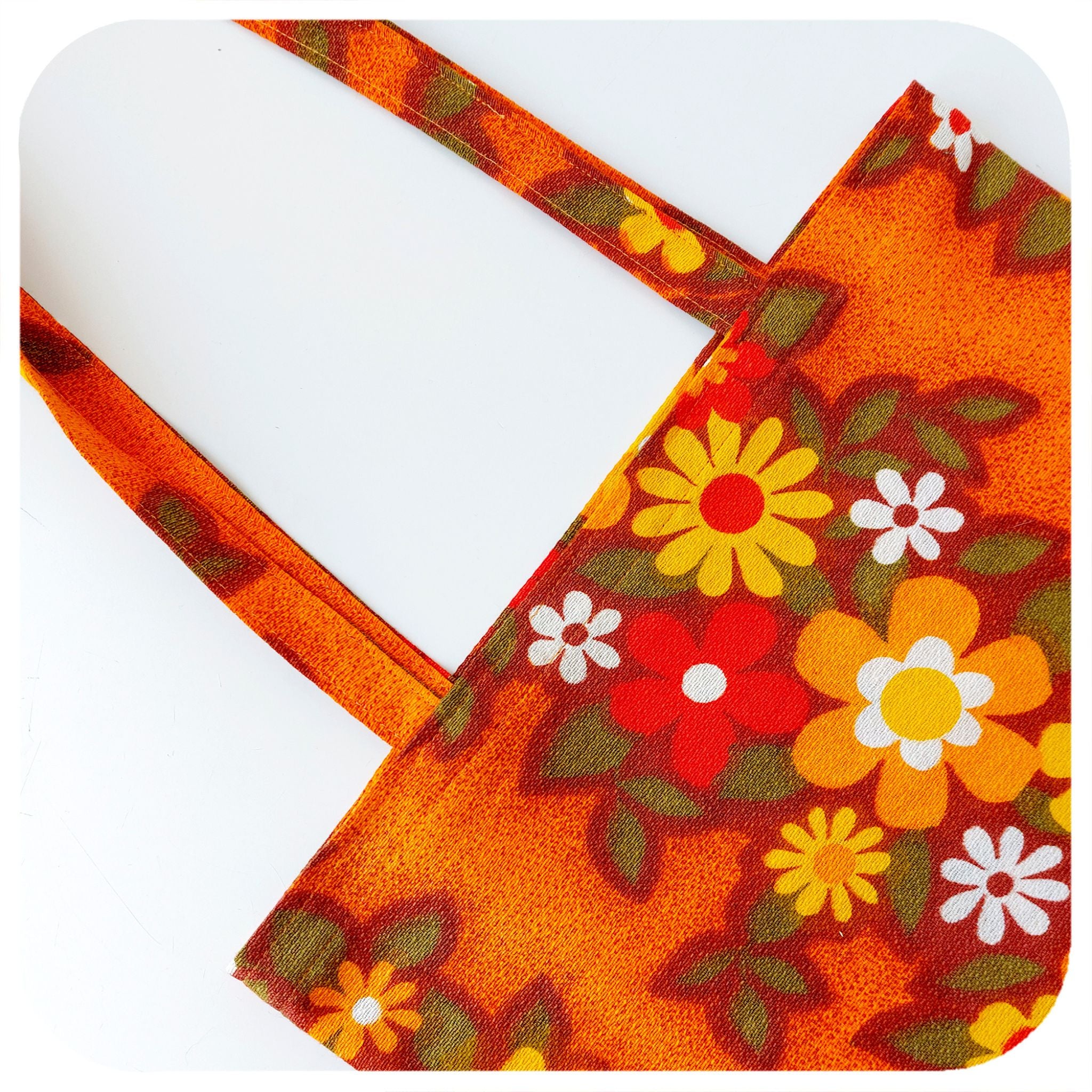Close up shot of a Vintage Fabric Tote Bag featuring vibrant florals in orange, yellow & red | The Inkabilly Emporium