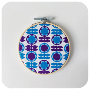 Vintage fabric hoop, featuring a floral repeat pattern in blues and purples | The Inkabilly Emporium