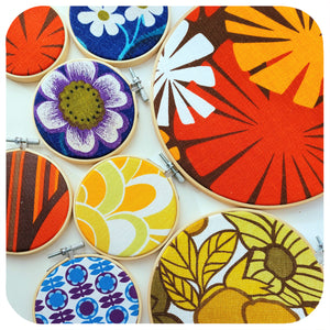A selection of framed vintage fabric hoops in different designs  on a white background | The Inkabilly Emporium
