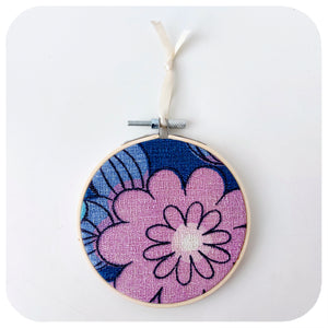 A framed fabric hoop featuring a midcentury barkcloth floral design in lilac and blue | The Inkabilly Emporium