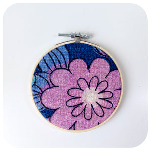 A framed fabric hoop featuring a midcentury barkcloth floral design in lilac and blue | The Inkabilly Emporium