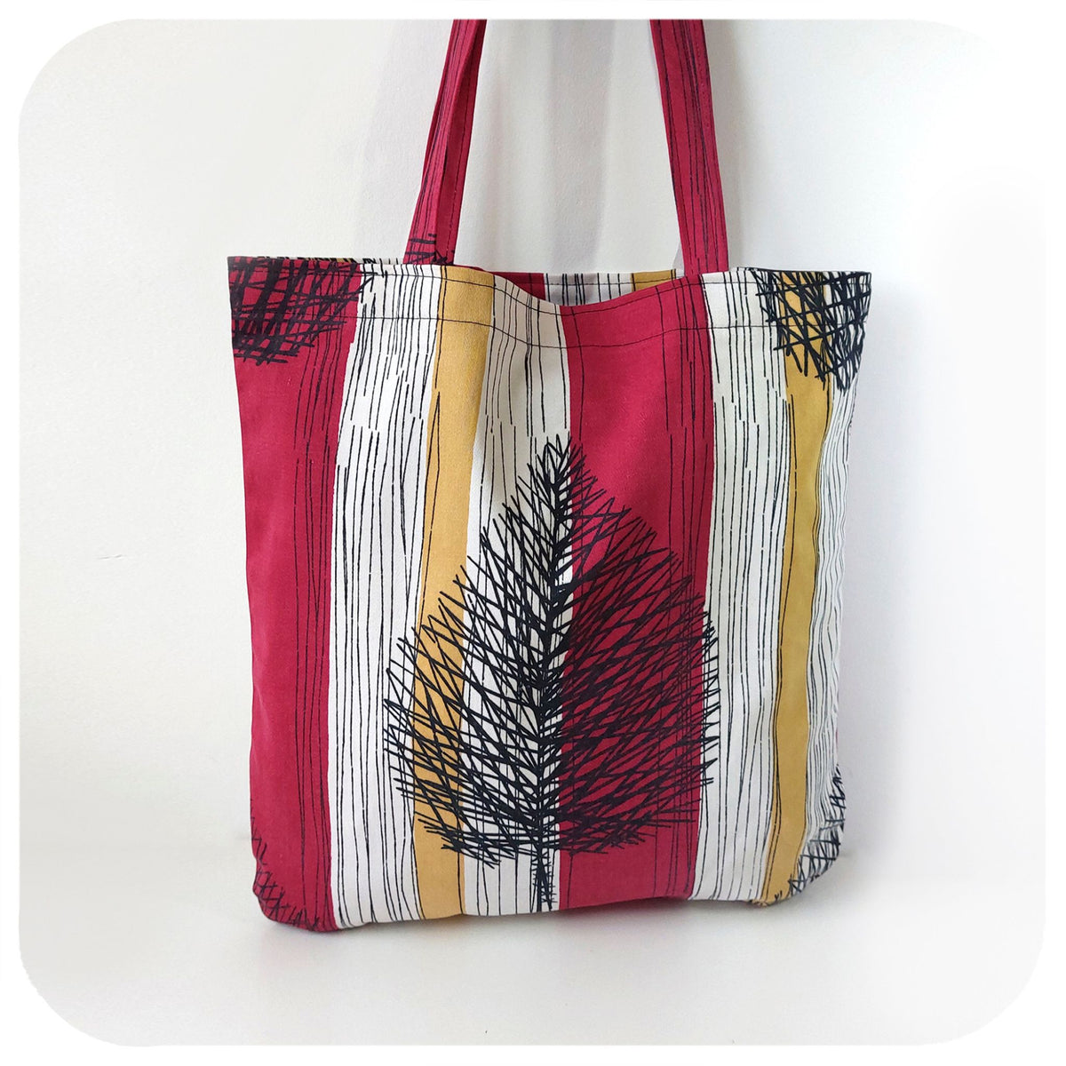 Tote bag with red, yellow, and white pattern on a white background