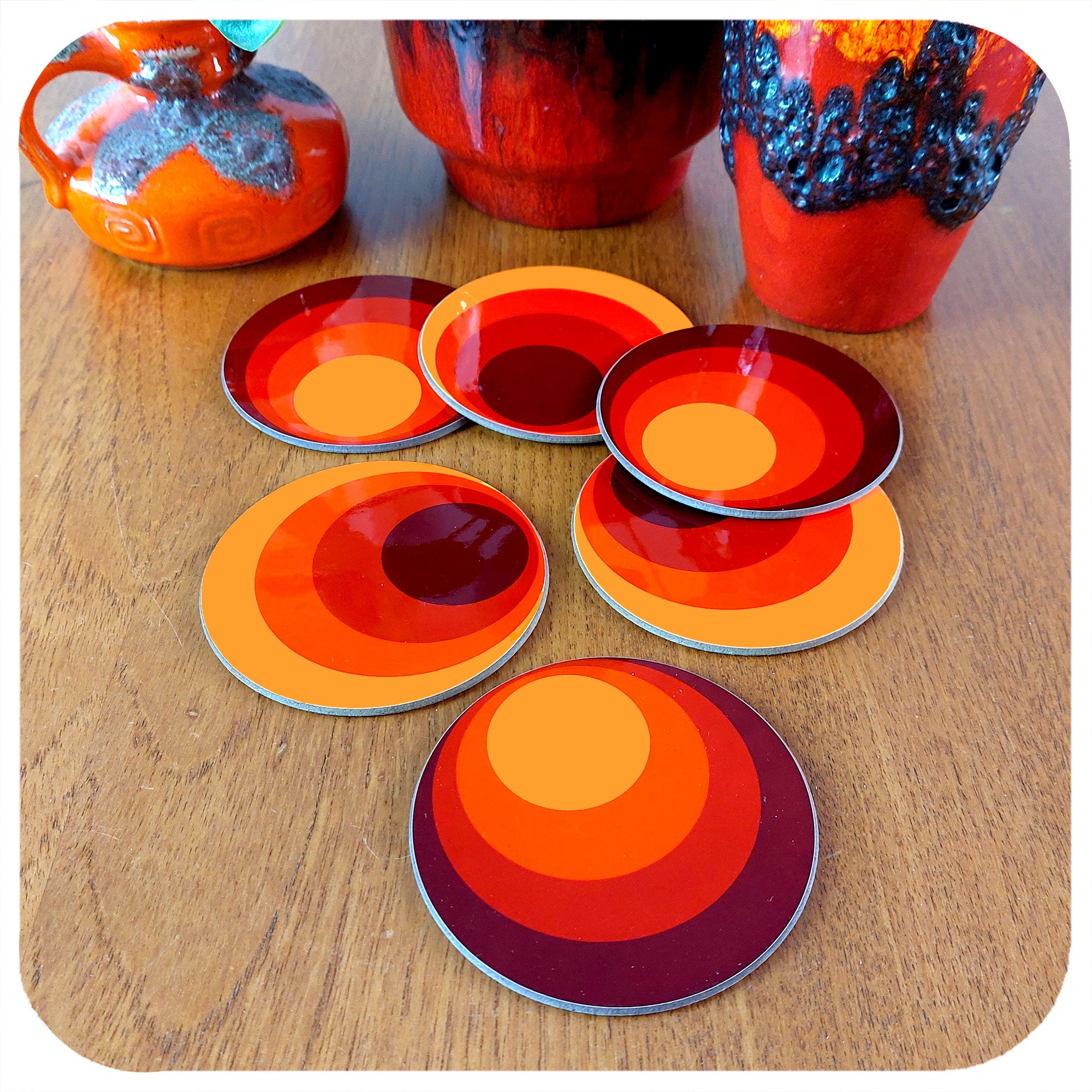 Set of Six Round 70s style coasters on a teak table with fat lava vases | The Inkabilly Emporium
