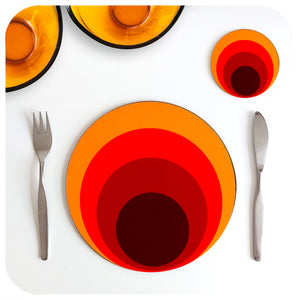 70s style round placemat and matching coaster are set on a white table with mid century cutlery and a couple of orange 70s glass dishes | The Inkabilly Emporium