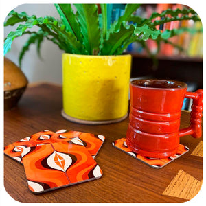 70s Orange Op Art Coasters on table with vintage mug and house plant | The Inkabilly Emporium
