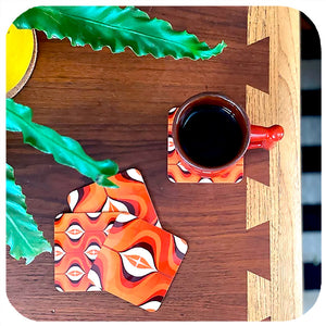 70s Orange Op Art Coasters on table with vintage mug and house plant - birdseye view | The Inkabilly Emporium