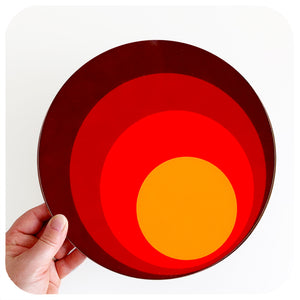 70s style round placemat is held by a hand against a white background | The Inkabilly Emporium