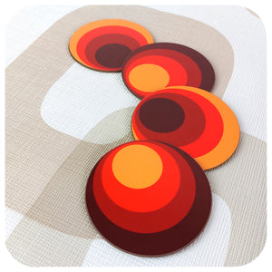 Four 70s style round coasters on a  retro patterned background | The Inkabilly Emporium