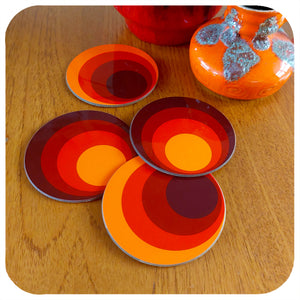 Four 70s style round coasters on a teak table with fat lava vases | The Inkabilly Emporium