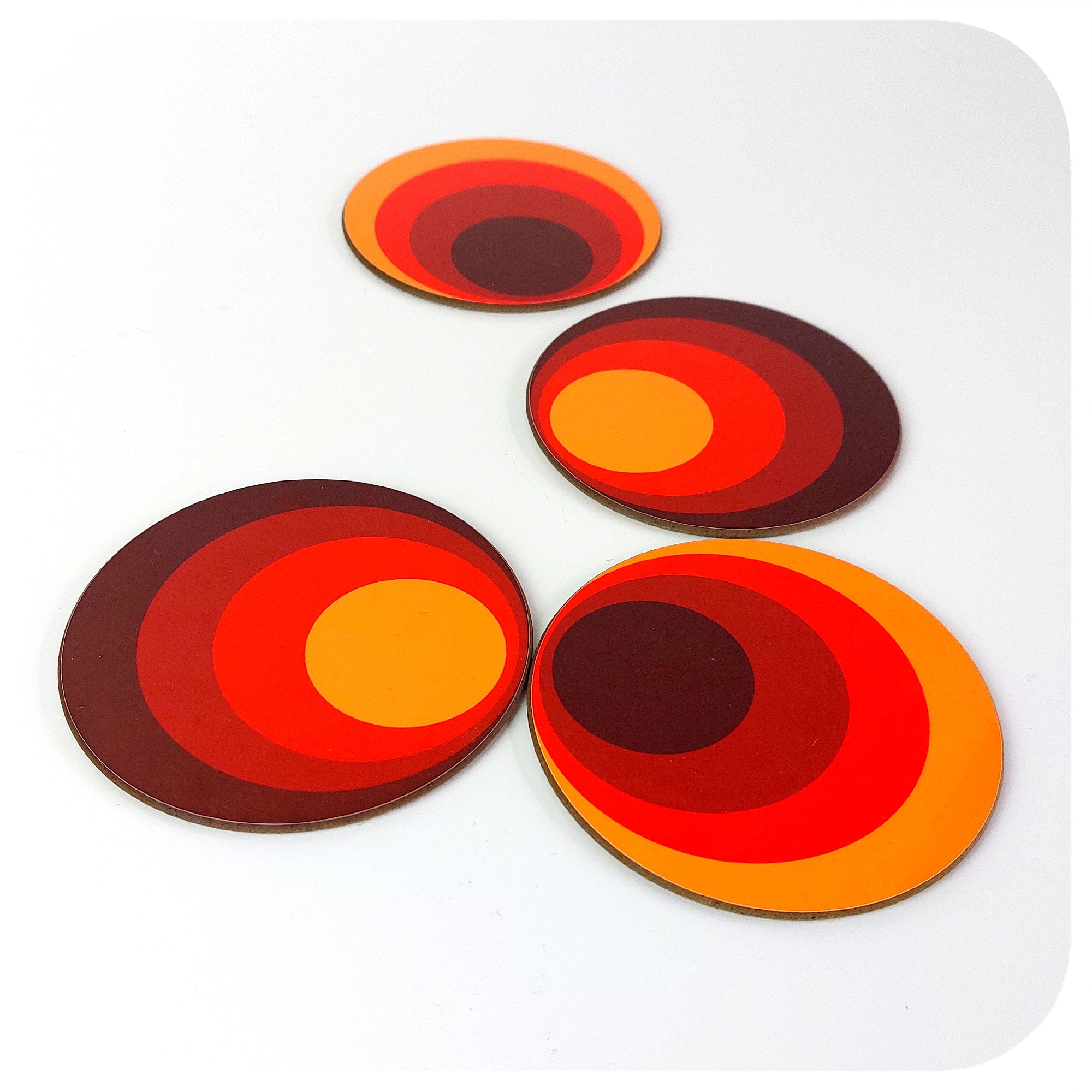 Four 70s style round coasters on a white table | The Inkabilly Emporium