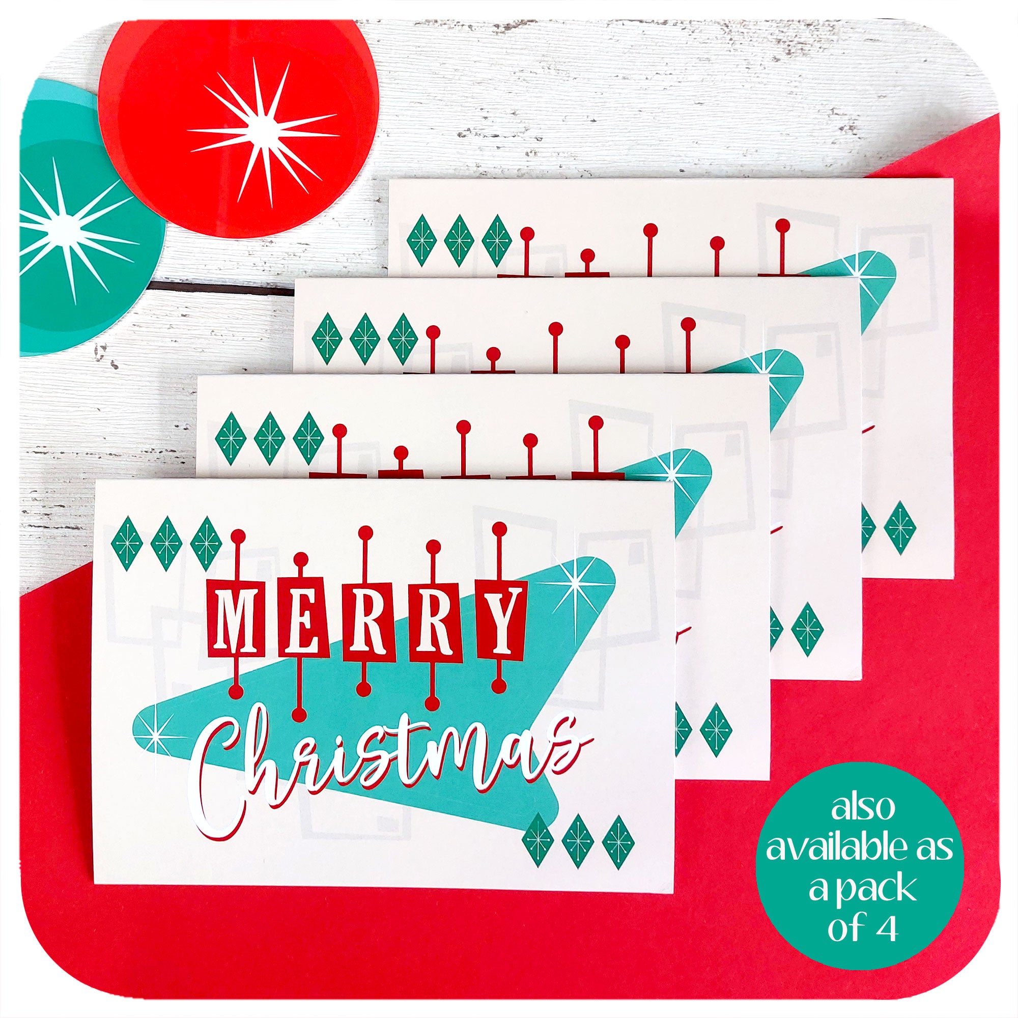 Four Atomic style Christmas cards are on a red and white woodgrain table with 50s style Christmas decorations. Text reads "also available as a pack of 4"  | The Inkabilly Emporium