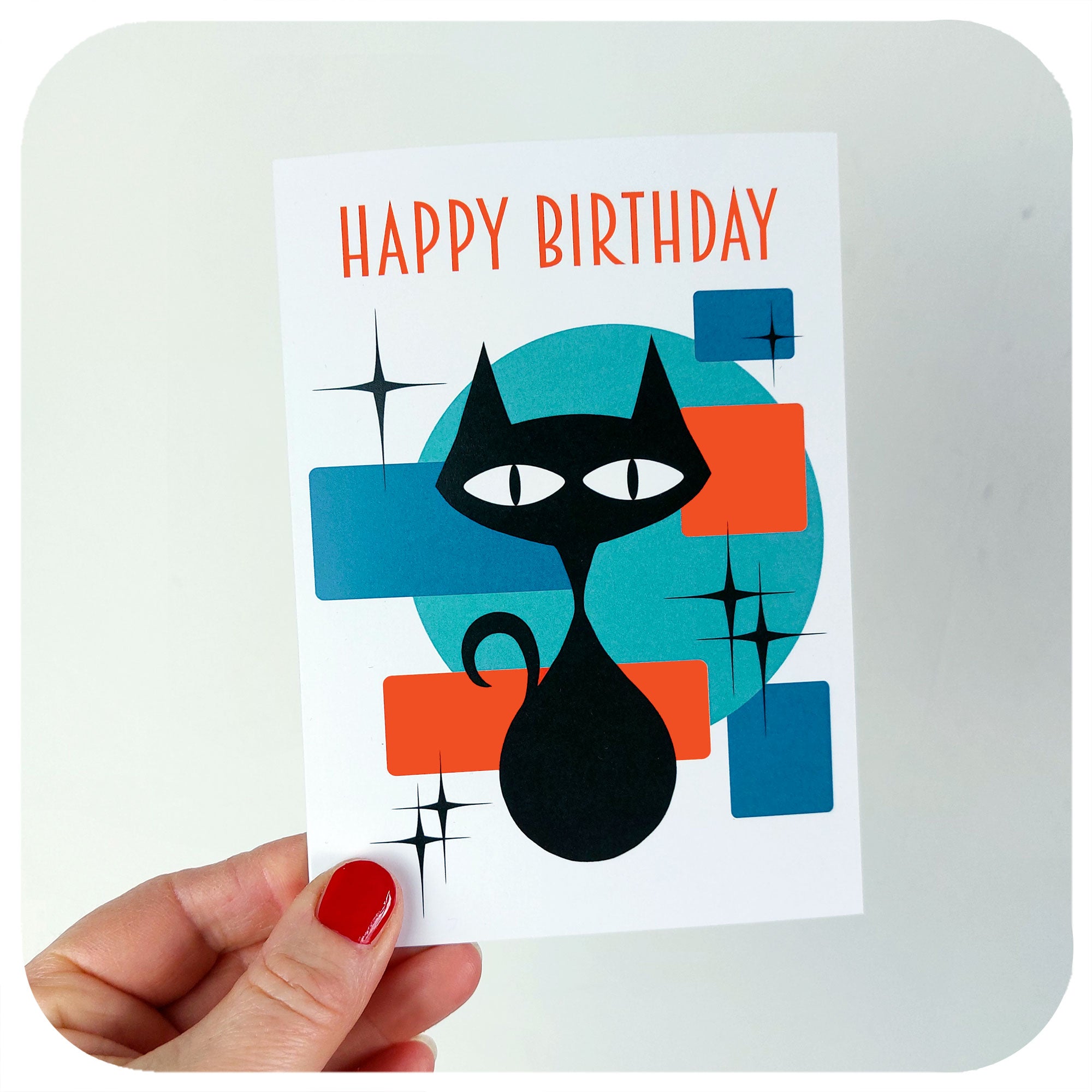 Atomic Cat Birthday Card being held up against a white background | The Inkabilly Emporium