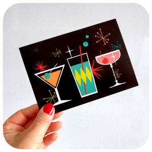 Cosmic Cocktails Christmas Card, held by hand | The Inkabilly Emporium