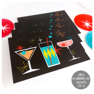 Four Cosmic Cocktails Christmas Cards, on a white table with retro Christmas decorations | The Inkabilly Emporium